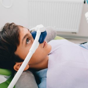 Little boy getting Inhalation Sedation while teeth treatment at dental clinic. Teeth treatment child